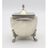 An Edwardian silver tea caddy, by William Devenport, Birmingham 1905, of shaped square form, on four