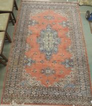 A lot comprising terracotta ground Persian style rug with multicoloured central medallion,