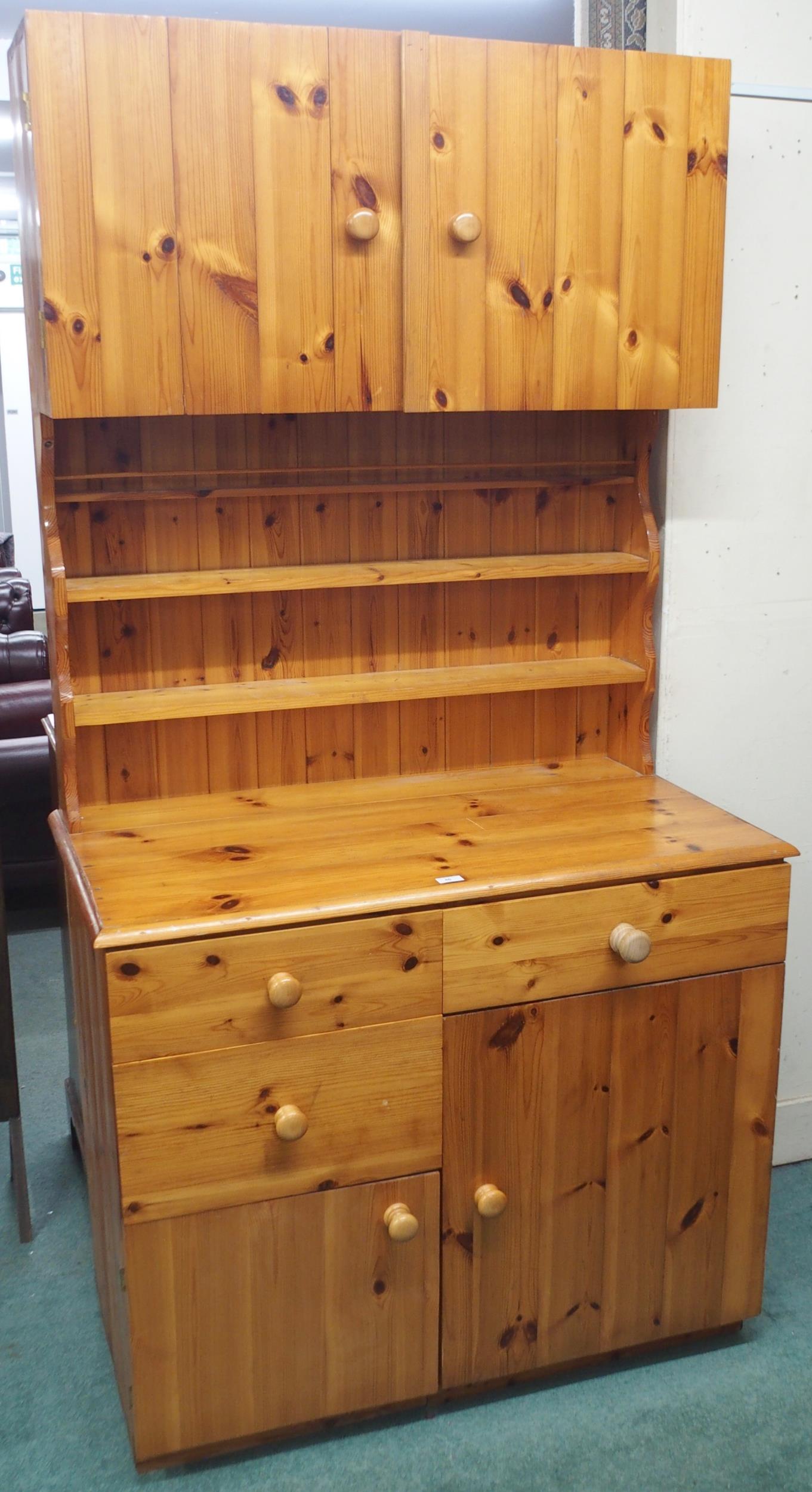 A 20th century pine estate built kitchen cabinet with pair of cabinet doors over open plate rack