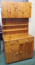 A 20th century pine estate built kitchen cabinet with pair of cabinet doors over open plate rack