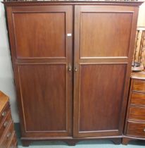 An early 20th century mahogany "Compactom Ltd" two door gents compactum wardrobe with fitted