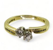 An 18ct gold twin stone diamond ring, set with estimated approx 0.30cts of brilliant cut diamonds,
