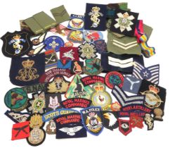 Assorted military cloth patches, with a number of bullion-embroidered examples, including the