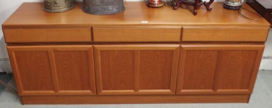 A mid 20th century teak sideboard with three drawers over three cabinet doors, 69cm high x 181cm