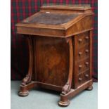 A Victorian walnut veneered Davenport writing desk with brass galleried top over hinged stationary