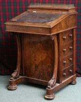 A Victorian walnut veneered Davenport writing desk with brass galleried top over hinged stationary