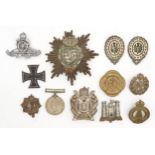 An Imperial German Saxony pickelhaube or busby plate, a WW1-period Iron Cross, assorted military cap