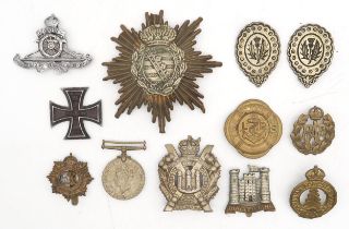 An Imperial German Saxony pickelhaube or busby plate, a WW1-period Iron Cross, assorted military cap