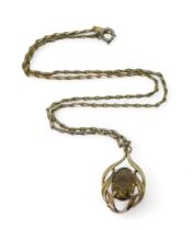 A 9ct gold smoky quartz pendant with a gold plated Monet chain, weight of the pendant approx 3.