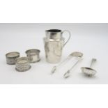 A collection of silver including a silver cream jug, by Charles Edwards, London, silver napkin