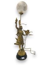 After E Rousseau, a gilded spelter lamp modelled as a maiden holding a flower in one hand and a