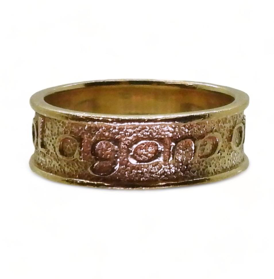 A 9ct gold ring with embossed Celtic phrase 'Tha gaol agam ort' - I Love you, made by Ola Gorie,