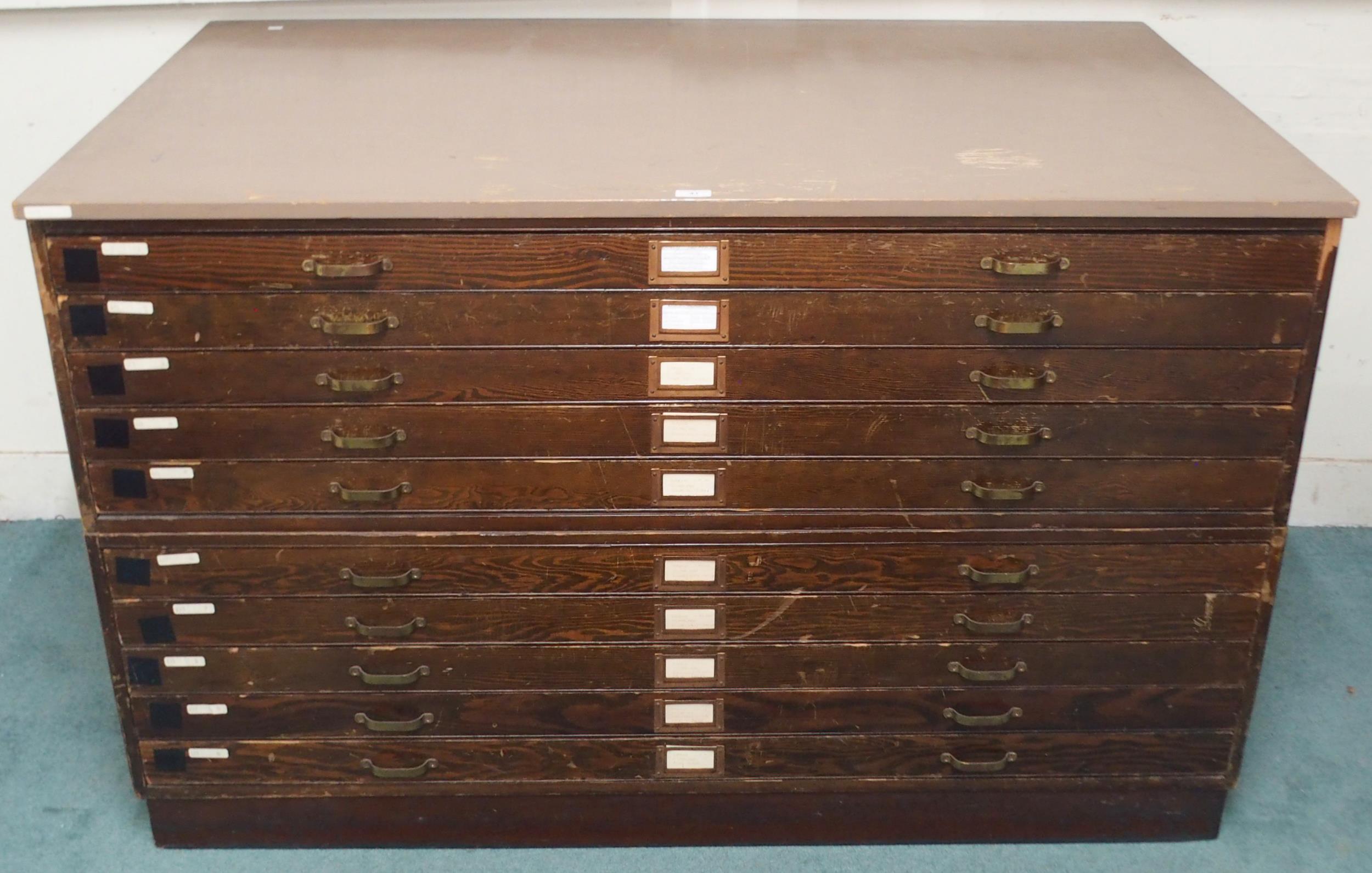 A 20th century pitch pine plan chest with painted top over ten narrow folio drawers on plinth