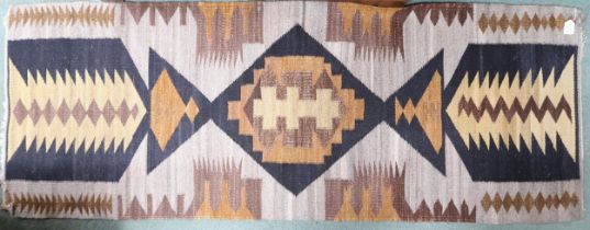 A beige ground Kilim runner with multicoloured geometric patterned ground, 194cm long x 73cm wide