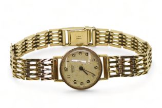 A 9ct gold ladies record De Luxe watch and strap, length 18.5cm, diameter approx 2cm, weight