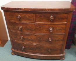 A late Victorian mahogany bow front two over three chest of drawers on bun feet, 107cm high x