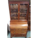 A late Victorian mahogany bureau bookcase with two door astragal glazed bookcase top on cylinder