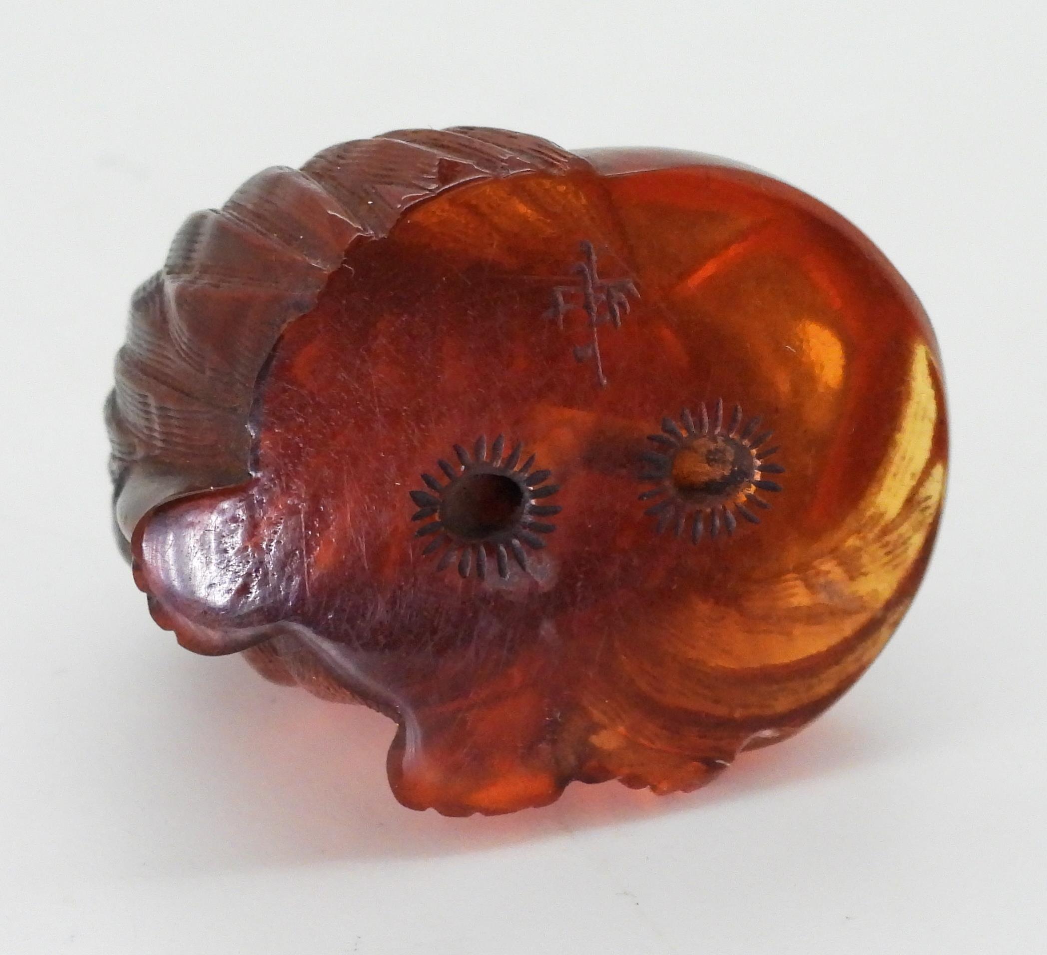 A collection of amber coloured items to include, a signed cat inro, a carved snail, amber specimens, - Image 3 of 16