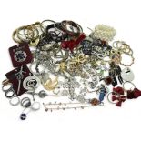 a collection of silver and costume jewellery to include silver bangles, an amber brooch, a silver
