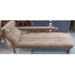 A Victorian oak framed chaise longue with contemporary leopard fabric upholstery on turned supports,