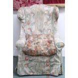 A late Victorian wing back armchair with floral cover on turned front supports, 117cm high x 77cm