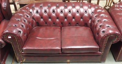 A 20th century burgundy leather buttonback upholstered two seater Chesterfield style club sofa, 73cm