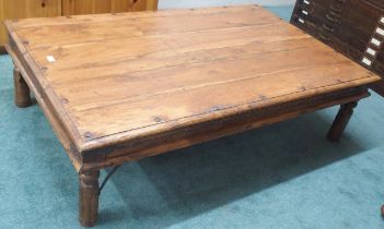 A late 20th century mango wood and metal bound coffee table, 40cm high x 145cm long x 92cm deep