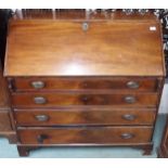 A Georgian mahogany writing bureau with fitted fall front writing compartment over four drawers on
