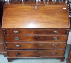 A Georgian mahogany writing bureau with fitted fall front writing compartment over four drawers on