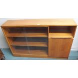 A mid 20th century teak bookcase with pair of glass sliding doors alongside cabinet door, 86cm