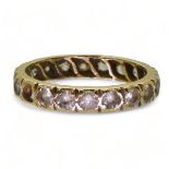 An 18ct gold full eternity ring set with synthetic spinels, finger size M1/2, weight 2.7gms