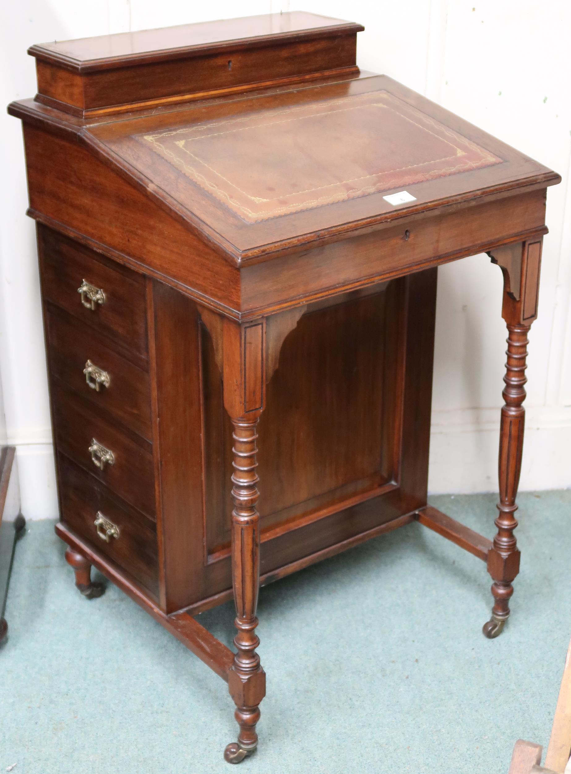 A Victorian mahogany Davenport with hinged writing compartment over four drawers to right hand side,