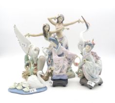 A group of Lladro porcelain including a pair of girls dancing, two Geishas, two Heron groups and a