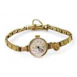 A 9ct gold ladies Record watch and strap, circa 1962 with attached St. Christopher, weight including