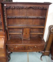 A 19th century oak Welsh style dresser with moulded cornice over pierced apron over shelves and