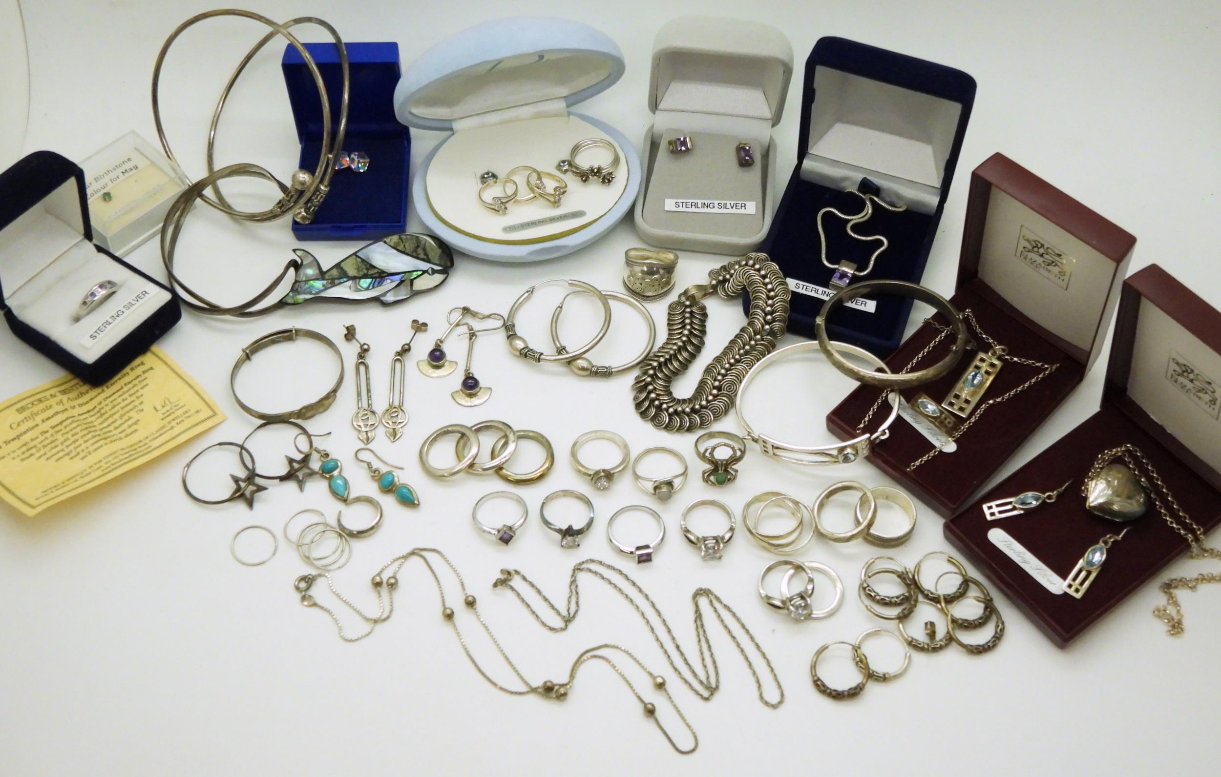 A collection of silver and white metal jewellery to include A spiral link bracelet, a Brooks &
