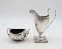 A George III silver cream jug, probably by Peter & Ann Bateman, London 1793, of helmet form, with