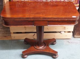 A Victorian mahogany fold over card table on octagonal pedestal on quadrupedal base with bun feet,