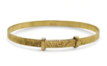 A 9ct gold expanding bangle with engraved pattern 9.1gms Condition Report:Available upon request