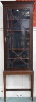 An early 20th century narrow astragal glazed display cabinet on square tapering supports, 178cm high