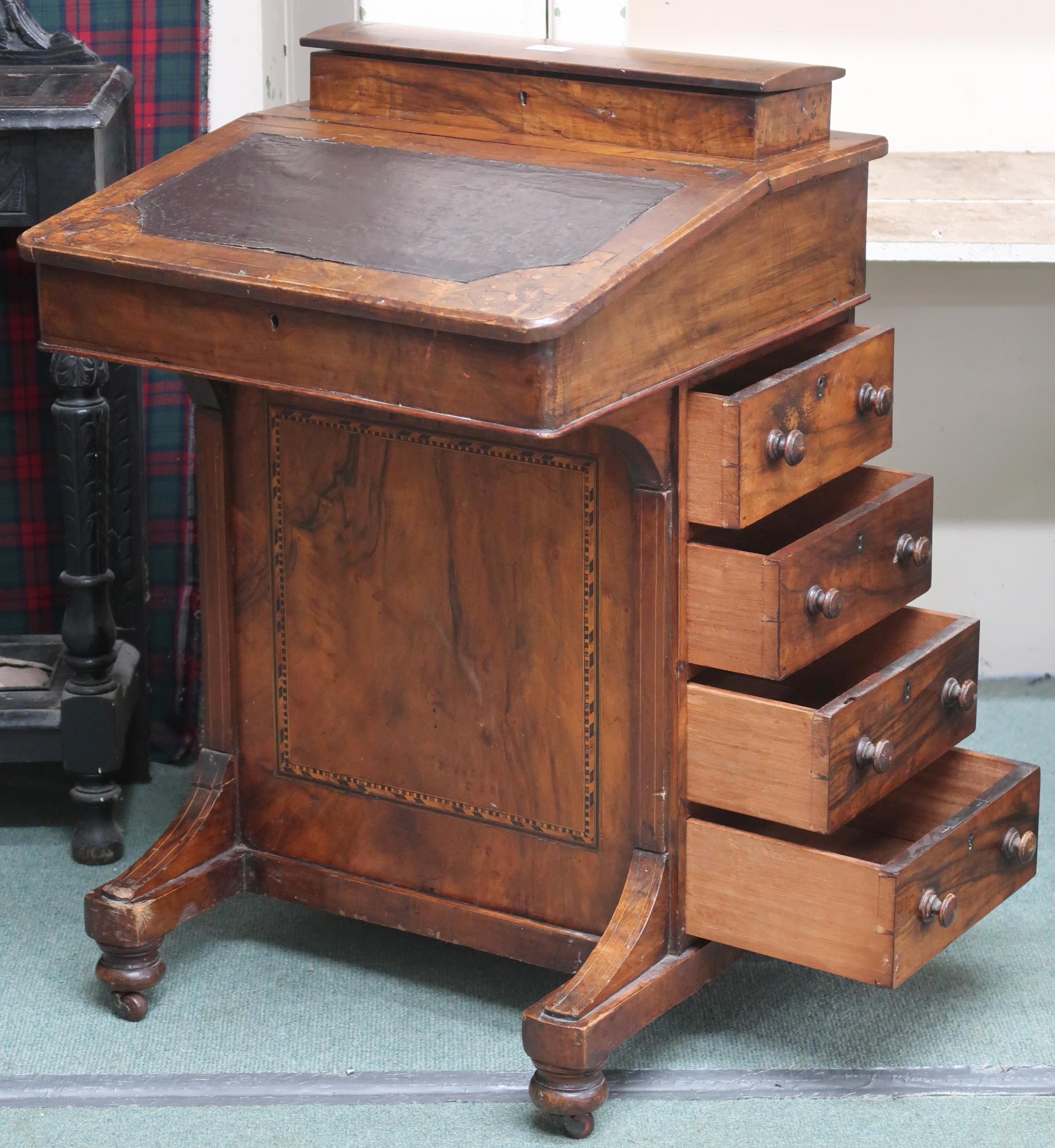 A late Victorian walnut veneered Davenport writing desk with hinged top writing compartment over