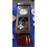 A wooden mantle clock together with a wall clock Condition Report:Available upon request