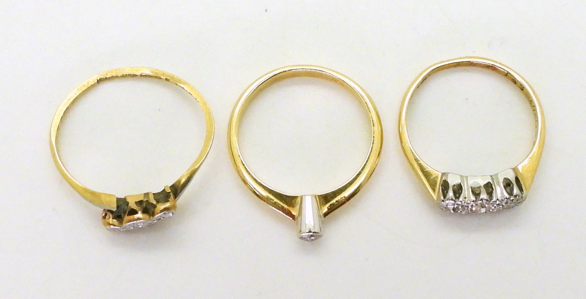 Three 18ct diamond rings, a 0.06ct solitaire size K, a illusion set three stone, size J, and a ( - Image 3 of 3