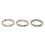 Three platinum wedding bands, Size two are L1/2, one L, weight together 10.8gms Condition Report: