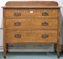 An early 20th century oak arts & crafts style three drawer chest with embossed copper drawer pulls