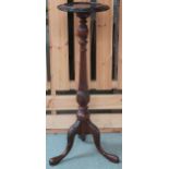 A 20th century mahogany jardiniere stand with carved circular top on turned column terminating in