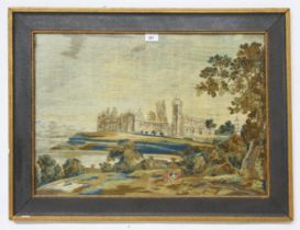 A framed woolwork landscape scene, depicting Linlithgow Palace, with two figures to the