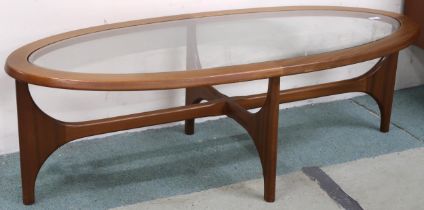 A mid 20th century teak G Plan Astro coffee table with glass inset oval table on shaped supports