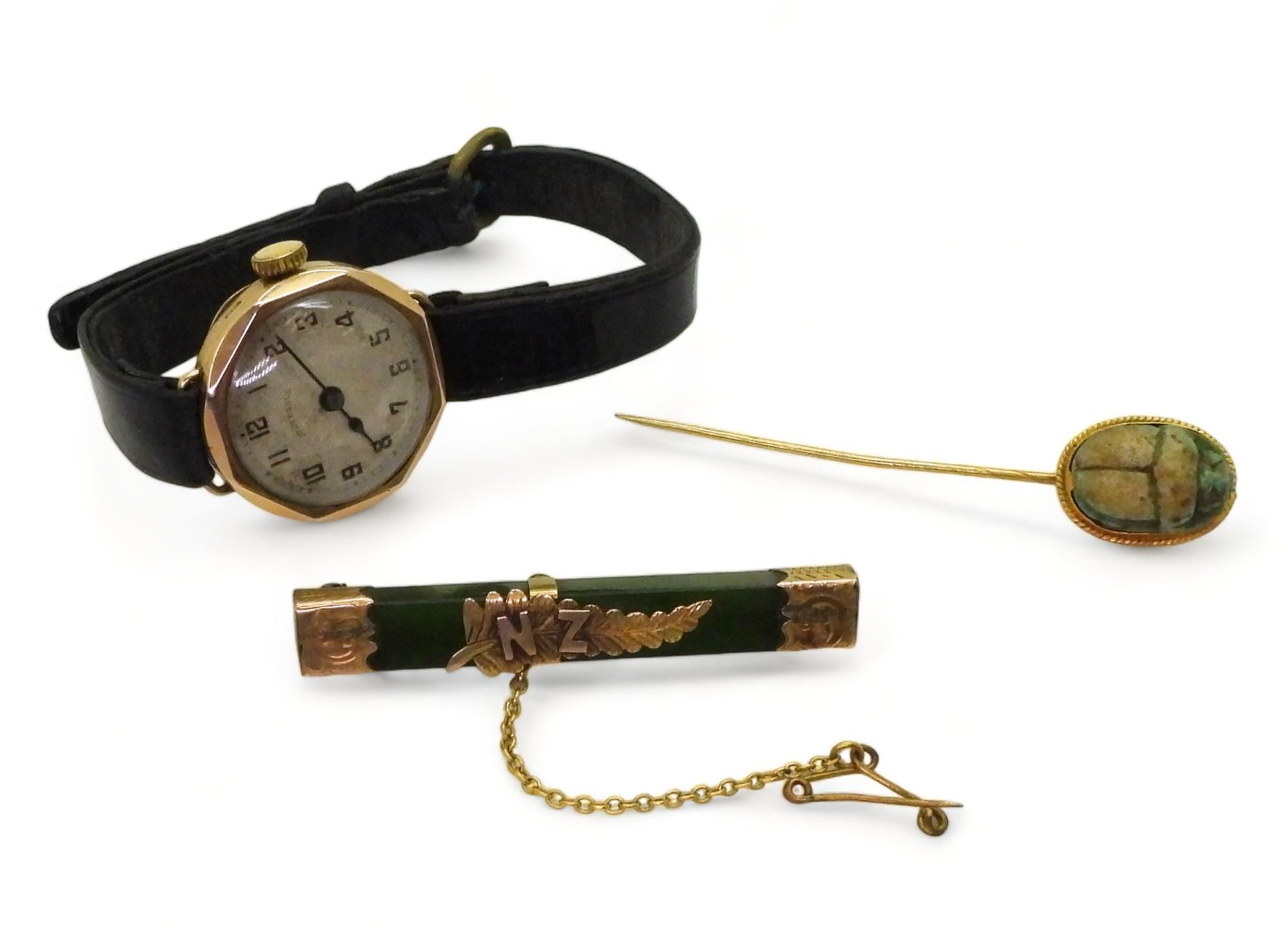 A 9ct gold cased Ingersoll watch, together with a 9ct gold mounted New Zealand jade brooch, together