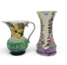 A Mary Fairgrieve pottery vase painted with Hollyhocks  together with a Mary Ramsay Strathyre jug